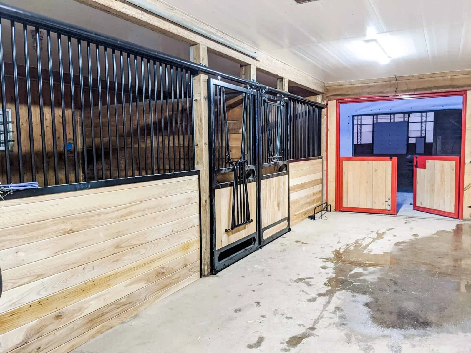 a horse stall with a door and a stall door
