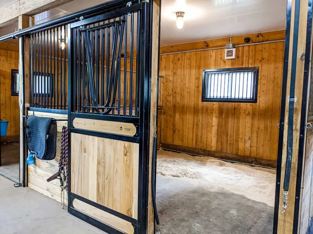 a horse stall with a door and a stall door