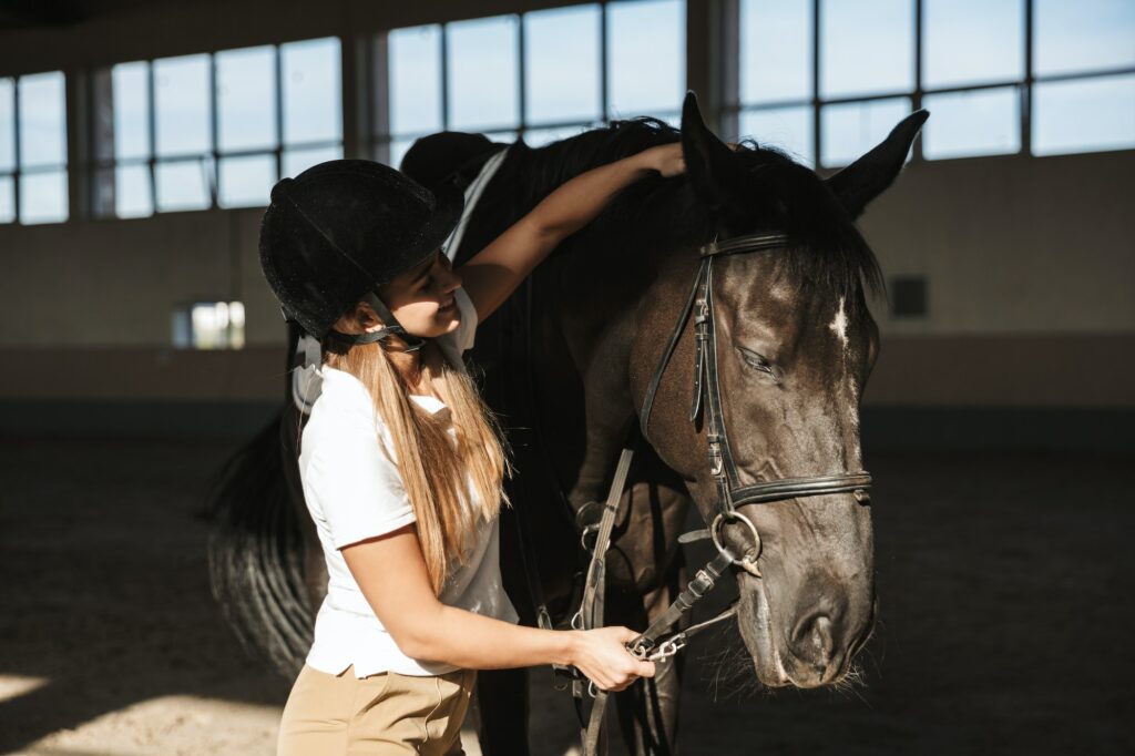 Beautiful woman wearing hat with horse